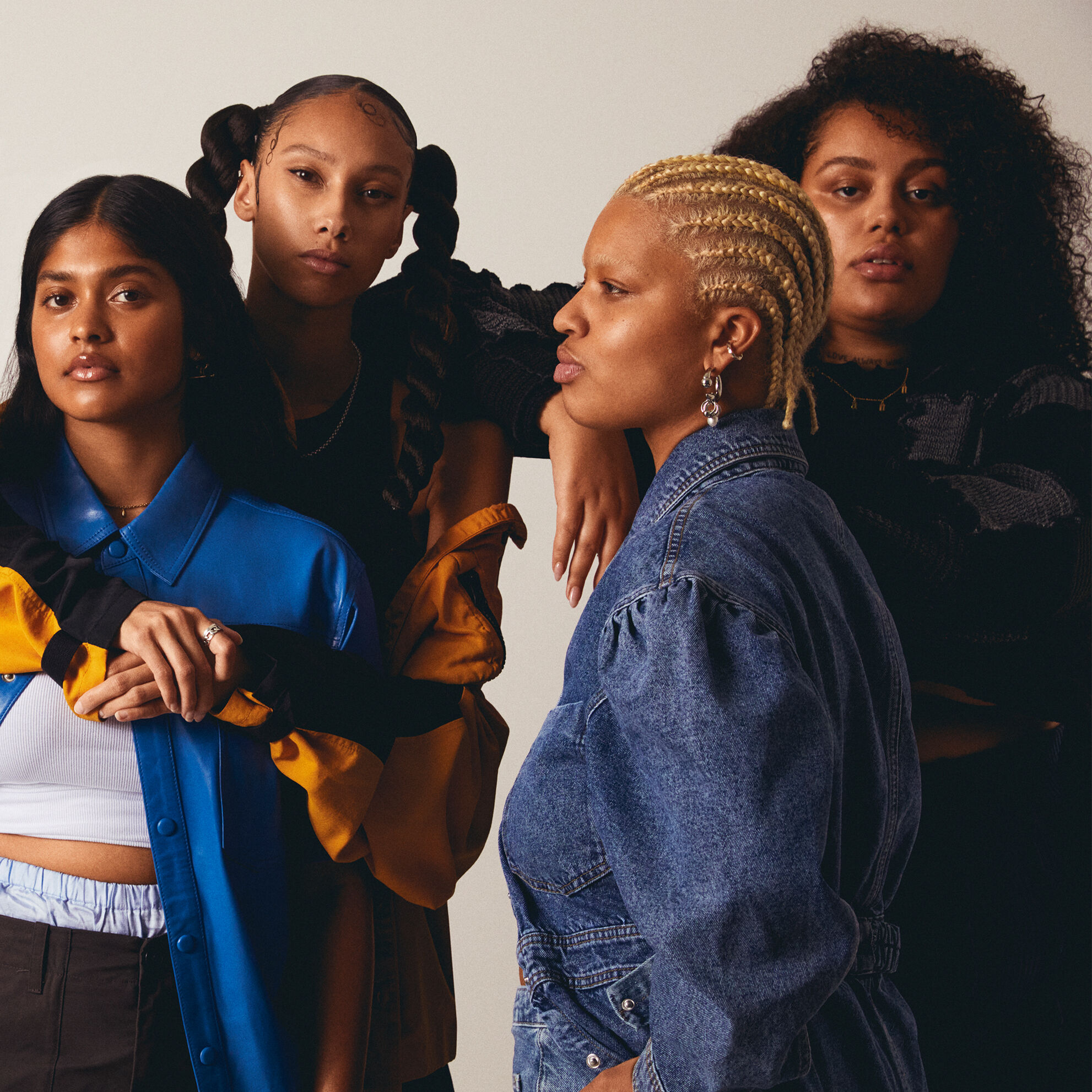 Group of young women of all races posing for the camera.
