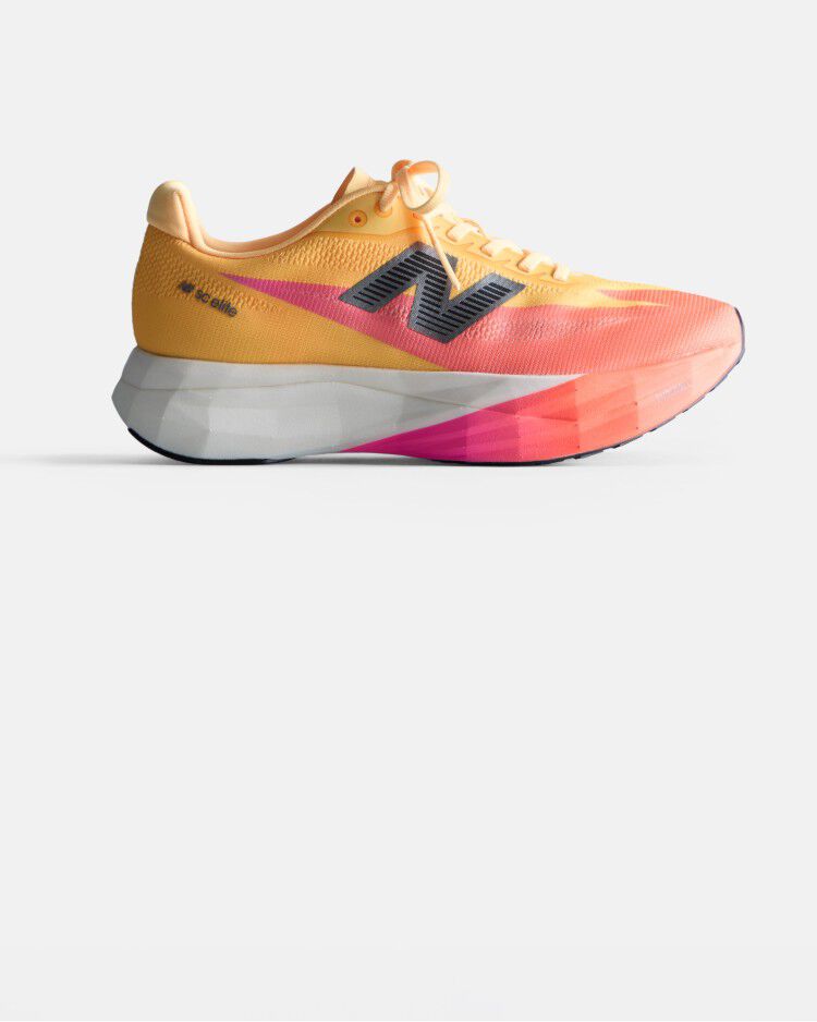 Orange and peach running shoe with a white midsole and black New Balance logo on a white background. 