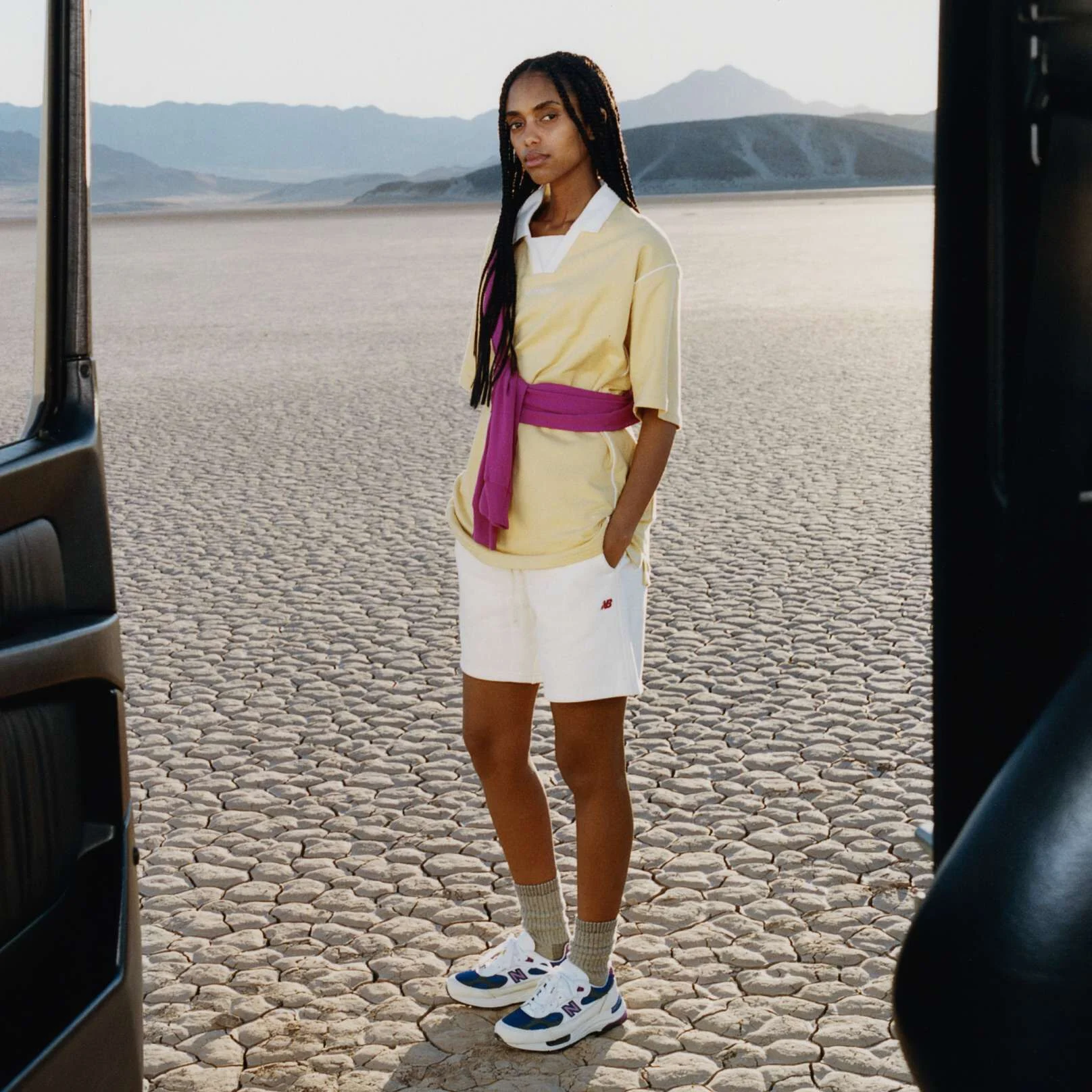 A woman standing in a desert environment wearing New Balance