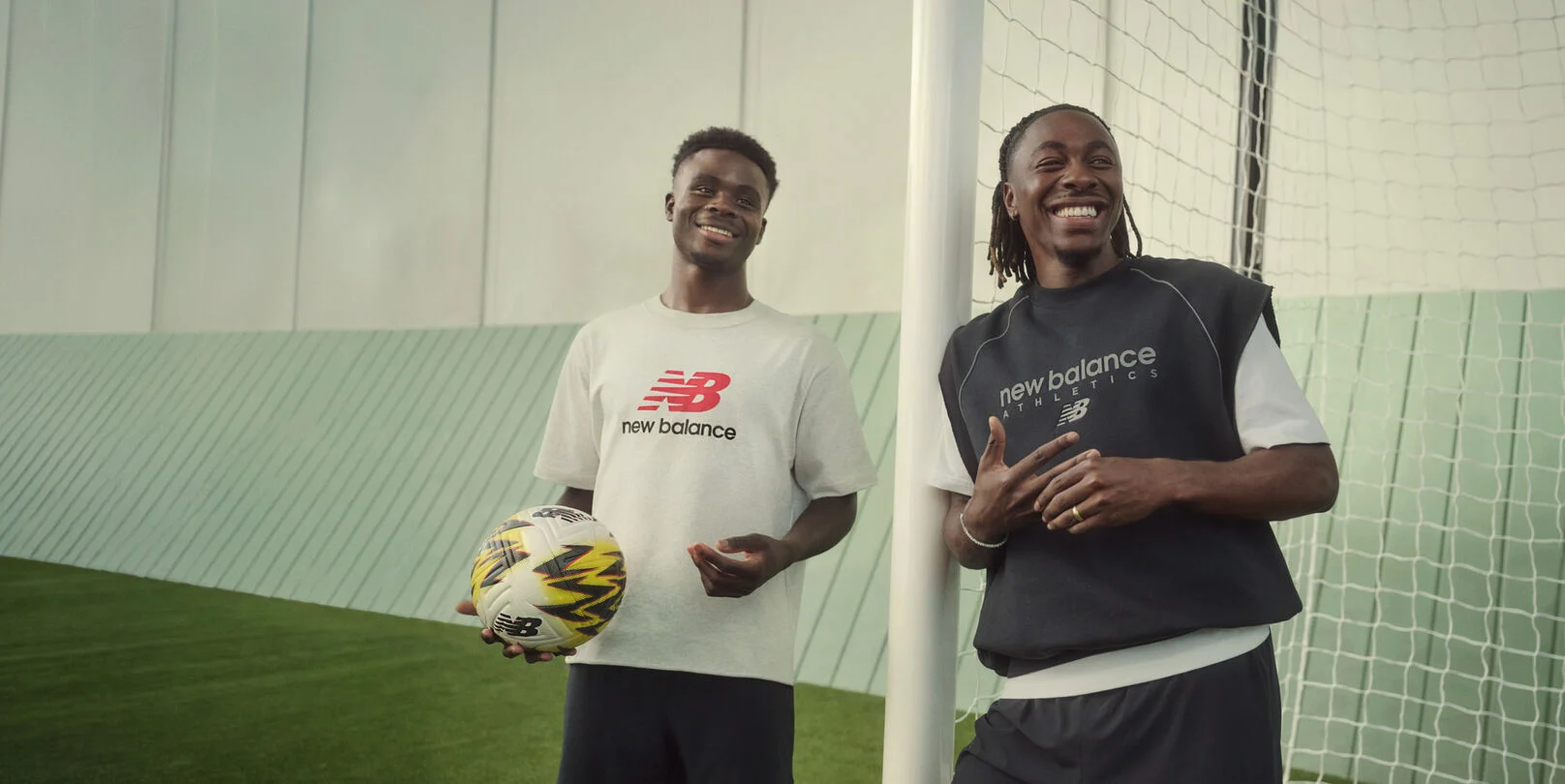 A group of soccer players standing on a soccer field. 
