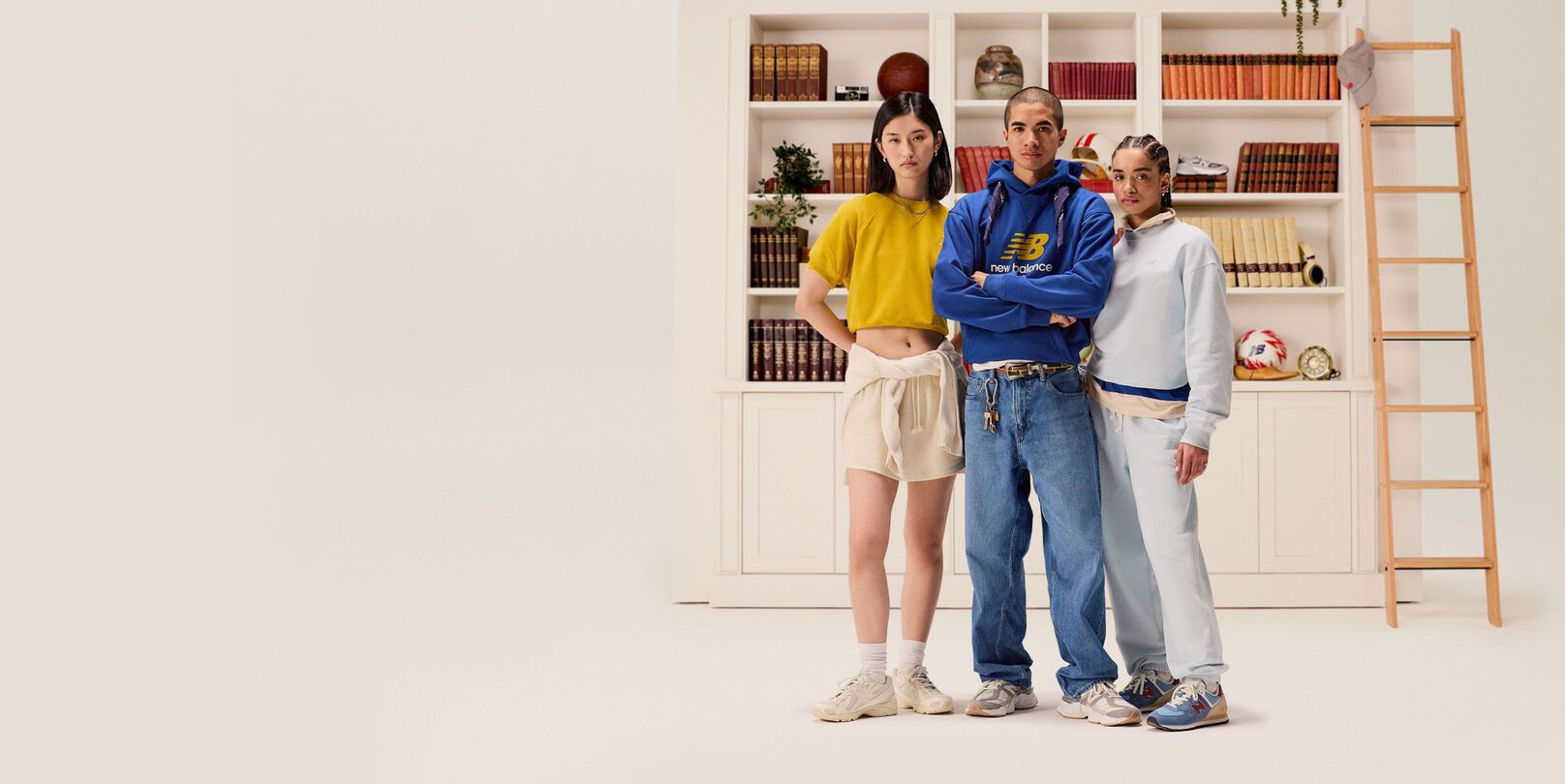 A group of people standing in front of a bookcase.
