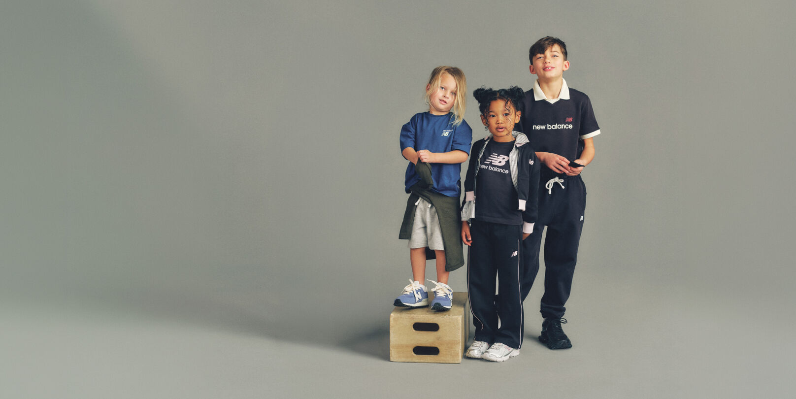 Three kids wearing head to toe New Balance