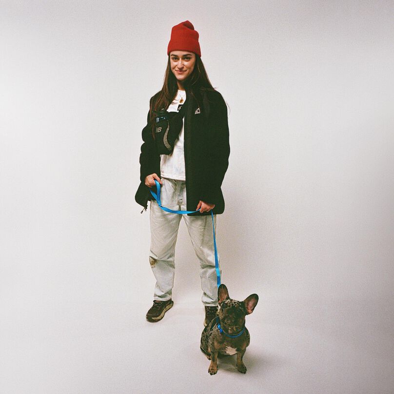 woman with dog on grey background