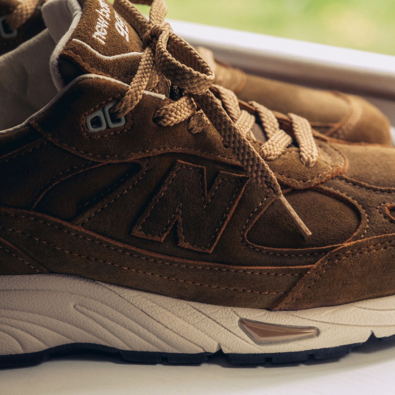 A close detailed view of a pair of New Balance Made in UK sneakers.