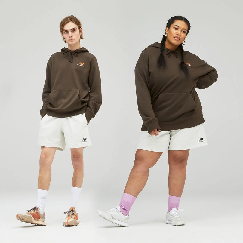 Male and female standing next to each other on a grey background.