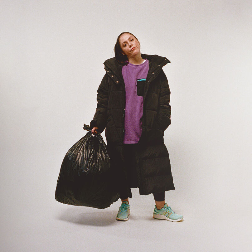 woman with jacket on grey background