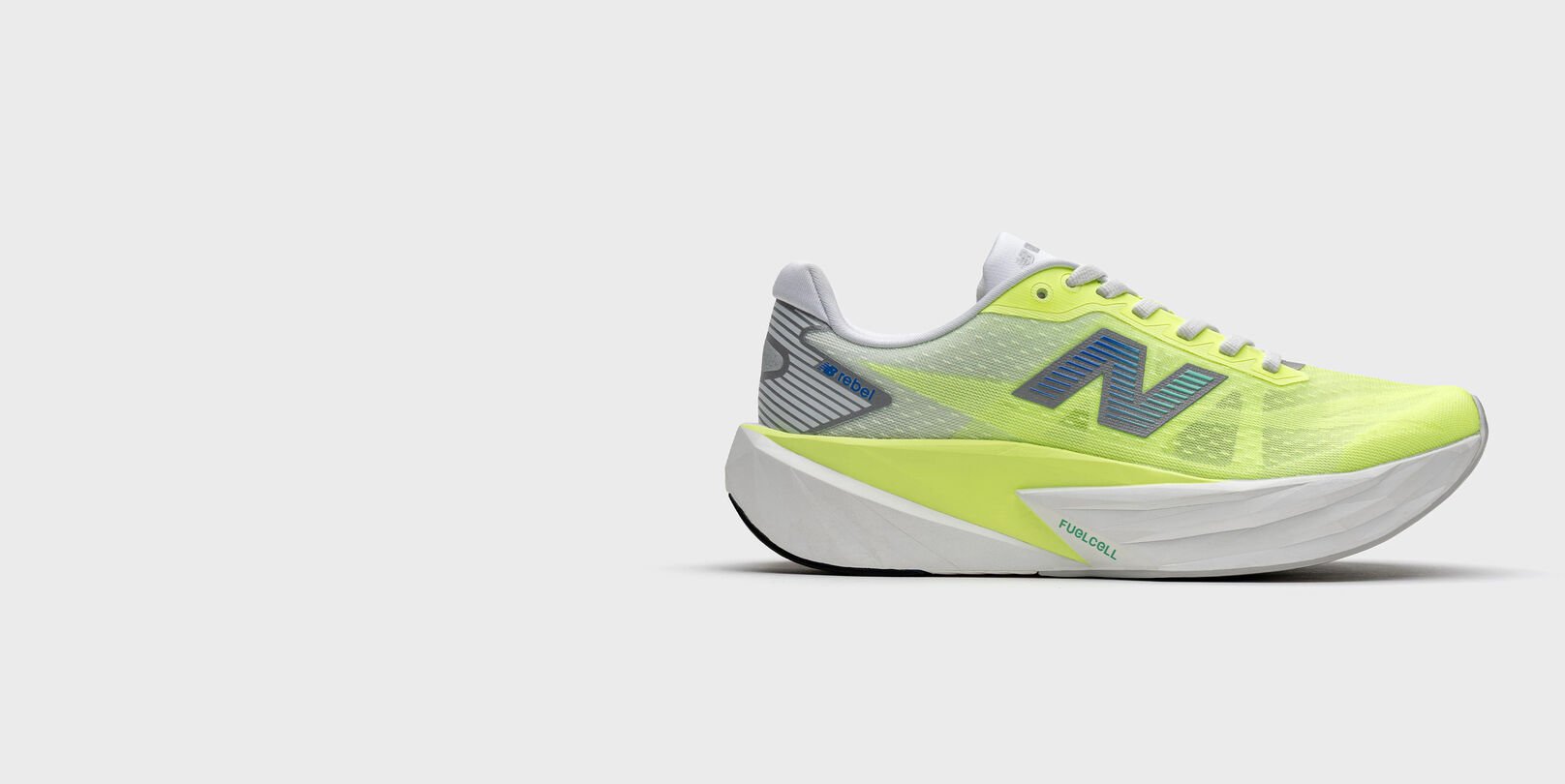Lime-yellow running shoe with a white midsole and blue New Balance logo, shown on a light gray background. 
